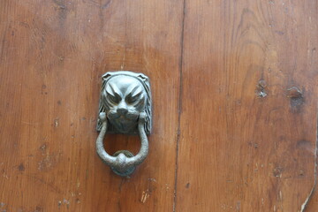 An old metal door knocker attached to the door