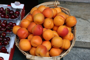 fresh apricots in a wicker basket on sale