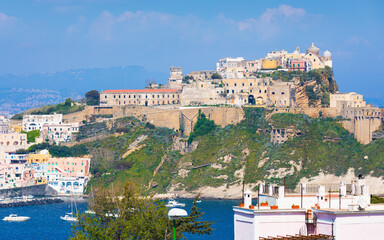 Terra Murata district, Procida Island, Italy. Historic architecture on cliff overlooking Tyrrhenian Sea. Colorful houses, boats, sunny day, clear sky. Welcome to Procida concept image