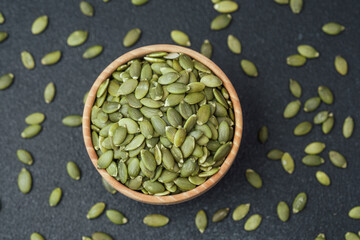 Pumpkin seeds in wooden bowl