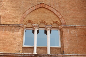 an arch window on an old Italian house in Siena, Italy