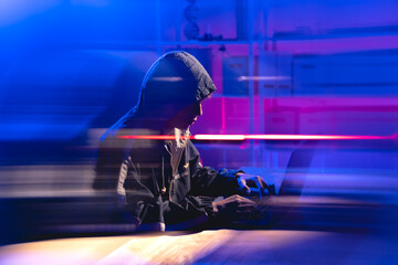 Young Coder in Dark Hoodie Working on Security in a Digital Realm