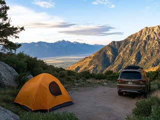 Orange camping tent and brown car on sunny mountaintop