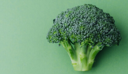 Broccoli on green background minimal healthy food concept