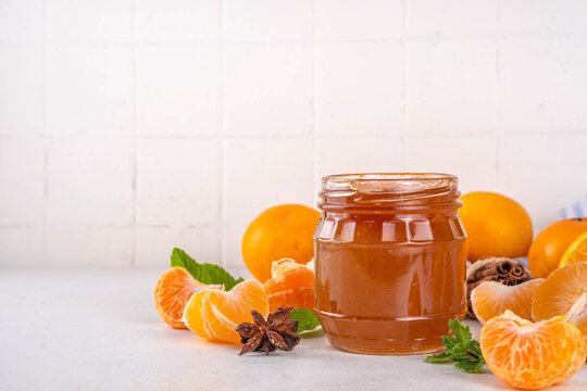 Golden sweet homemade tangerine jam, with spices and mint