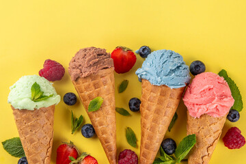  Colorful bright ice cream in waffle cones on bright background
