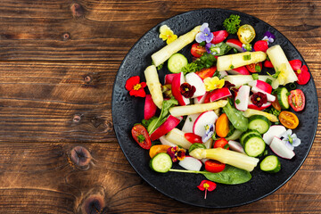 Fresh mixed salad with edible flowers.