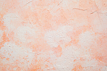 Peach pink stucco wall with mottled texture and soft light