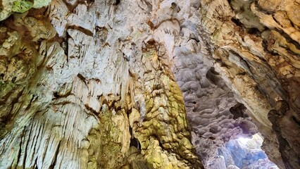 Dramatic stalactites and stalagmites inside Thien Cung Cave, a popular attraction in Ha Long Bay, Vietnam.