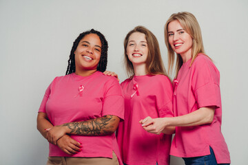Diverse women wearing pink ribbons supporting breast cancer awareness