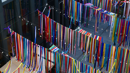 Aerial view of colorful ribbons hanging from the ceiling in an office building, symbolizing diversity and creativity