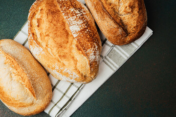 Freshly baked bread on a kitchen towel in a cozy home setting