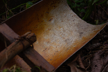 A close-up of the texture of a curved, old, and rusty metal surface. An abstract grunge background