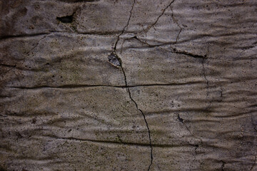 A macro close-up of the texture of an old, rough, and cracked concrete wall. An abstract grunge...