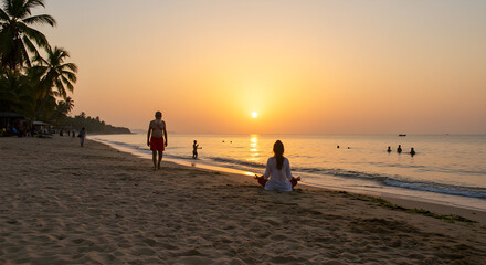 couple walking on beach at sunset