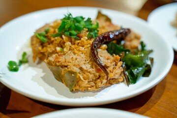 Delicious Thai Food Steamed Fish Curry in Banana Leaf Served on White Plate