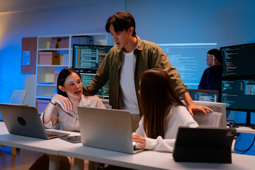 Asian software engineer or programmer team working late in development office,problem solving or...