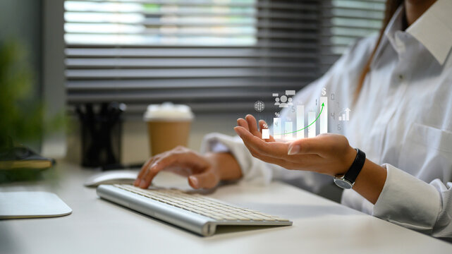Concept of financial analytics with digital bar graph and statistics hovering over hand