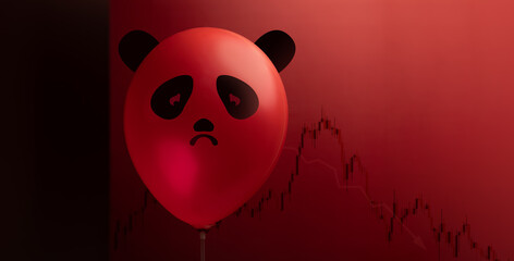 A sad panda balloon floats before a falling downward red stock graph, representing China’s declining economy, Business Slowdown and investment concerns