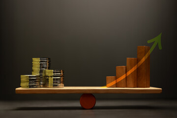 Growth Investment concept with Coin money Stack and Wooden balanced on a scale, representing financial and Profitable portfolio, and wealth accumulation through strategic