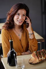 Young woman eat a club sandwich in a bar