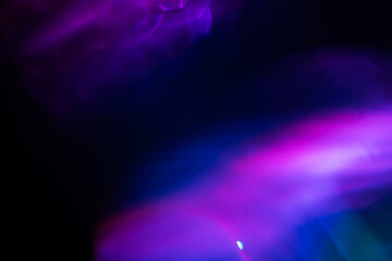 Abstract blurred colorful lens flare bokeh on black,