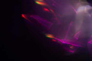Colorful light leak on black background, abstract design with optical lens flare shot on a long lens