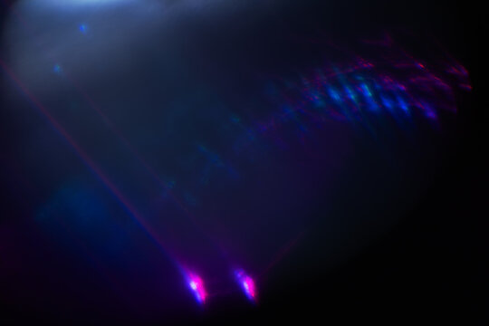 Abstract blurred colorful lens flare bokeh on black,