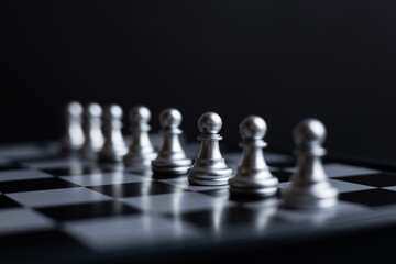 silver pawn chess on dark background