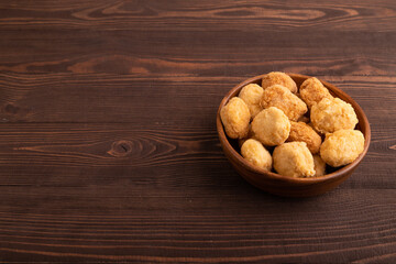 Fried crispy Chicken Nuggets on brown wooden. side view, copy space