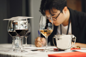Aspiring Sommelier Examines Nuances of Wine During Professional Certification Exam.