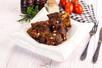 Prepared tasty beef ribs with sauce