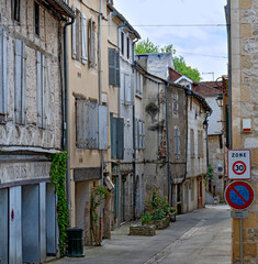  narrow street with old desolate residential buildings in Souillac in the region Perigord, France