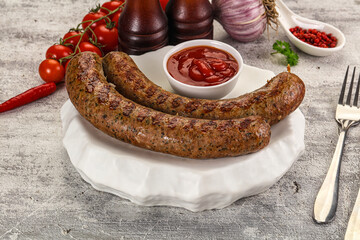 Grilled beef sausages with sauce