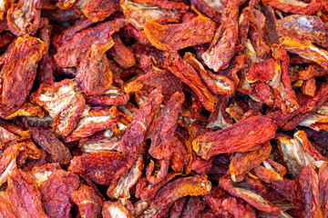 Background with home-grown dried red tomatoes seen from above. Concept of healthy food and organic farming.