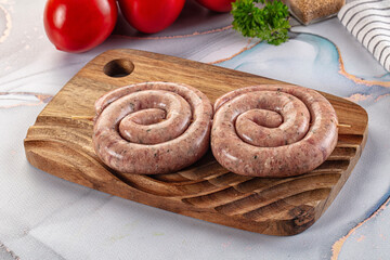 Raw meat pork and beef swirl sausages