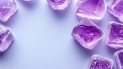 Purple translucent ice cubes scattered on light purple background with soft shadows and copy space, creating modern minimalist composition for beverage and cooling concepts.