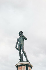 statue of david michellangelo minimalist over cloudy sky
