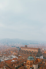 Obraz premium panorama of bologna italy with all red rooftops terracotta with foggy sky