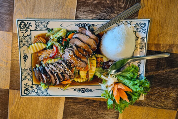 Grilled Teriyaki Chicken with Rice and Veggies on Decorative Plate for Food Presentation