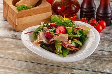 Salad with jamon, strawberry and arugula