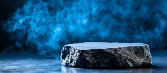 Stone platform with dramatic blue smoke effect on dark background creates mysterious atmosphere for product display and promotional content.