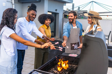 Friends roasting marshmallows at rooftop barbecue party