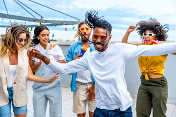 Friends dancing and having fun at rooftop party