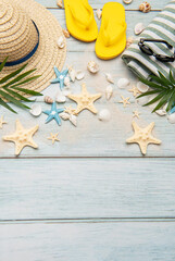 Summer accessories creating a frame on a wooden background with copy space