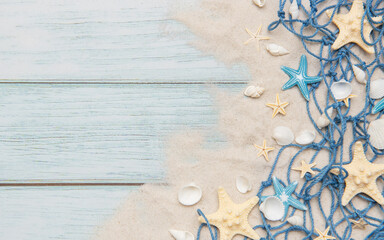 Fishing net, seashells and starfishes creating summer holiday border on wooden planks