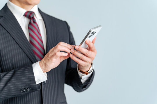 Middle-aged male business person using a smartphone