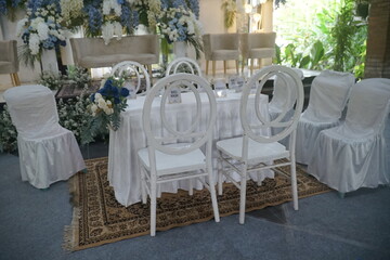 Elegant Wedding Ceremony Setup White Chairs, Floral Decor, and Romantic Ambiance