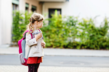 Cute little preschool girl going to playschool. Healthy toddler child walking to nursery school and...