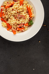 Rice meat and vegetables pilaf fresh delicious gourmet food background on the table rustic food top view copy space